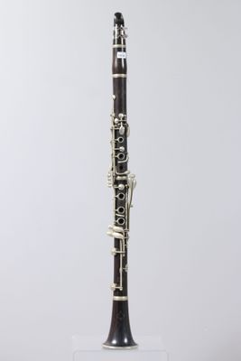 a close up of a clarinet on a white surface