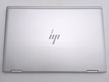 the back of a laptop computer sitting on top of a white table