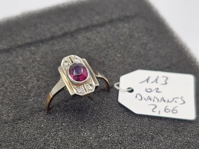 une bague ornée d'une pierre rose et sur laquelle est accrochée une étiquette de prix