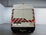a white van with red stripes parked in a room