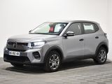 a silver suv parked in a room with a checkered floor
