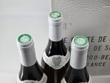 three bottles of wine that are sitting on a table