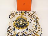 a square scarf with a gold and blue design on it