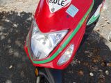 a red scooter with a green stripe on the front