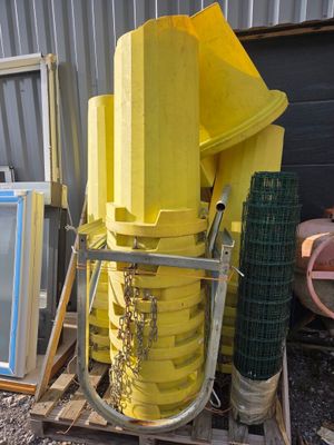 a lot of yellow items on a pallet next to a building