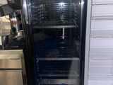 un réfrigérateur avec un ordinateur portable posé sur le plan de travail de la cuisine