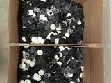 a cardboard box filled with lots of black and white sequins