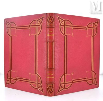 un vieux livre à la couverture rouge posé sur une table blanche