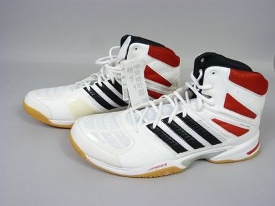 pair of white and black tennis shoes with red and black stripes