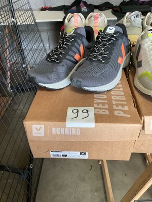 many pairs of running shoes on a box in a store