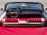 a red and white convertible car parked on the side of the road