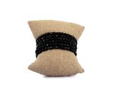 black beaded pillow with a black ribbon around it