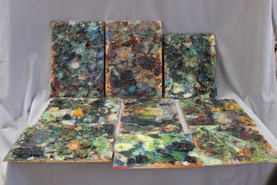 four pieces of art that are sitting on a table