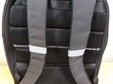 a black backpack with a white stripe on the back