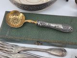 a silver spoon and a spoon rest on a book