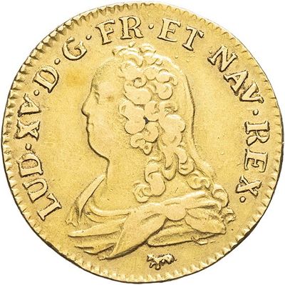 a close up of a gold coin with a woman ' s head on it