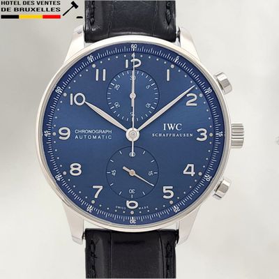 a close up of a wrist watch with a blue dial