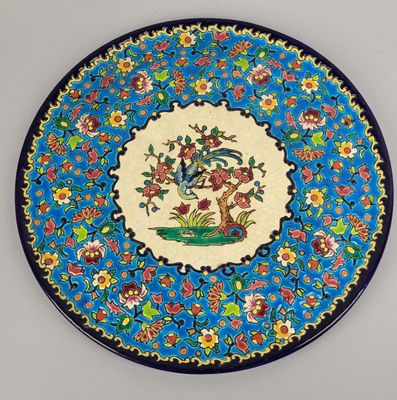 an image of a decorative plate with a bird and flowers on it