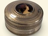 a silver box with a picture of a woman on it