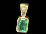 an emerald and diamond pendant on a black background
