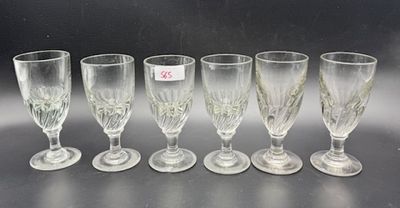 six wine glasses are lined up on a table with a price tag