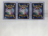 two pokemon trading cards are sitting on a white surface