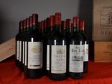 several bottles of red wine are lined up on a table