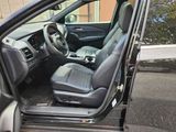 the interior of a car with the door open and the driver ' s seat down