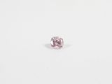 a pink diamond on a white surface