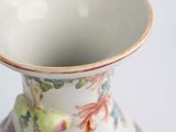 a white vase with a colorful floral design on it