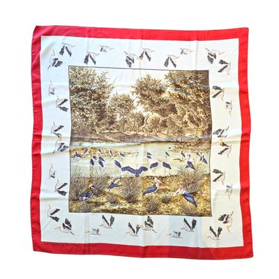 a red and white scarf with a picture of birds on it