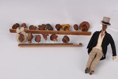 a figurine of a man sitting next to a shelf of donuts