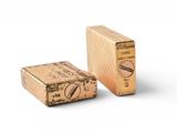 a small wooden box with a stamp on it next to a smaller wooden box with a stamp on it