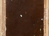 an old picture frame with some paint on it sitting on a table
