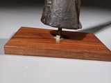a small statue of a woman on a wooden base