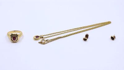a close up of a necklace, ring, and earring on a white surface