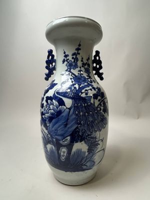 a blue and white vase sitting on a white surface