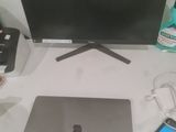 a laptop computer sitting on a desk next to a monitor