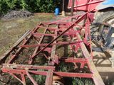 a red tractor that is sitting in the grass