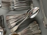 a lot of silver spoons and spoon spoons on the table