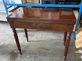 a wooden table with a mirror on top of it
