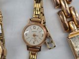 several watches and bracelets are sitting on a table