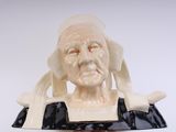 a statue of an old man with a hat on