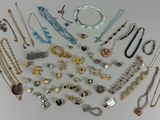 a lot of necklaces and bracelets on a table
