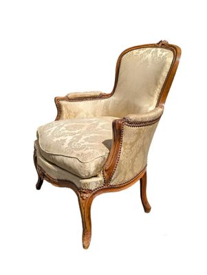an image of a chair with a beige upholstered seat