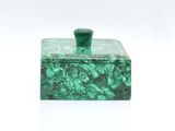 a close up of a green box on a white surface