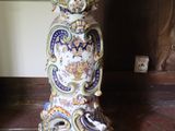 a vase that is sitting on the floor next to a wall