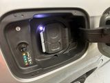 a close up of a car ' s fuel tank with a blue light
