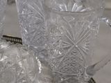 three clear glass vases sitting on a tray on a table