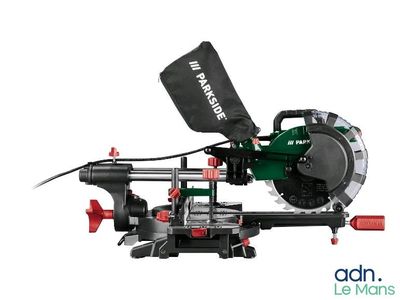 an image of a green and black circular saw on a white background